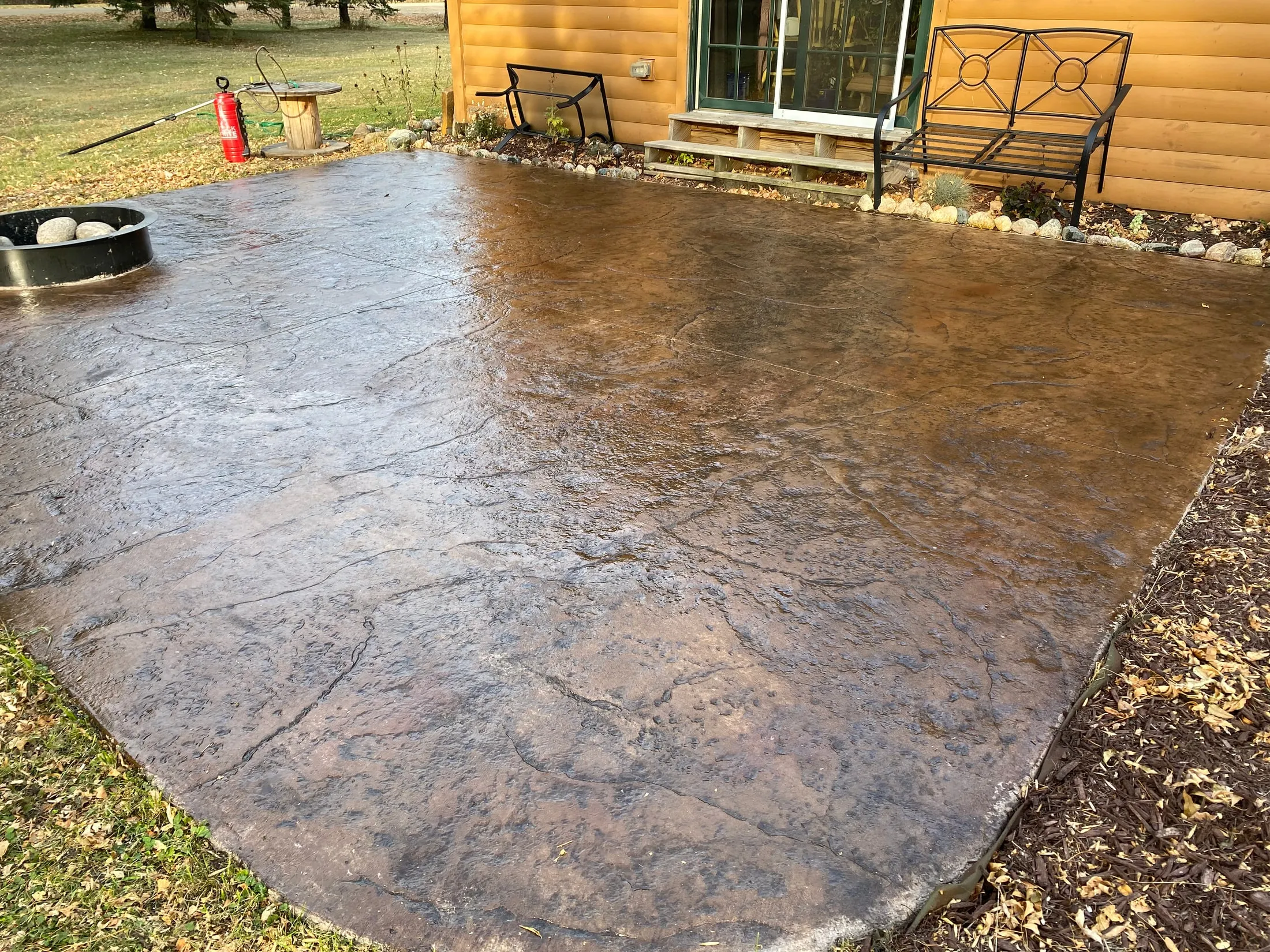 Texture detail across the sealed, color-finished stamped patio surface.