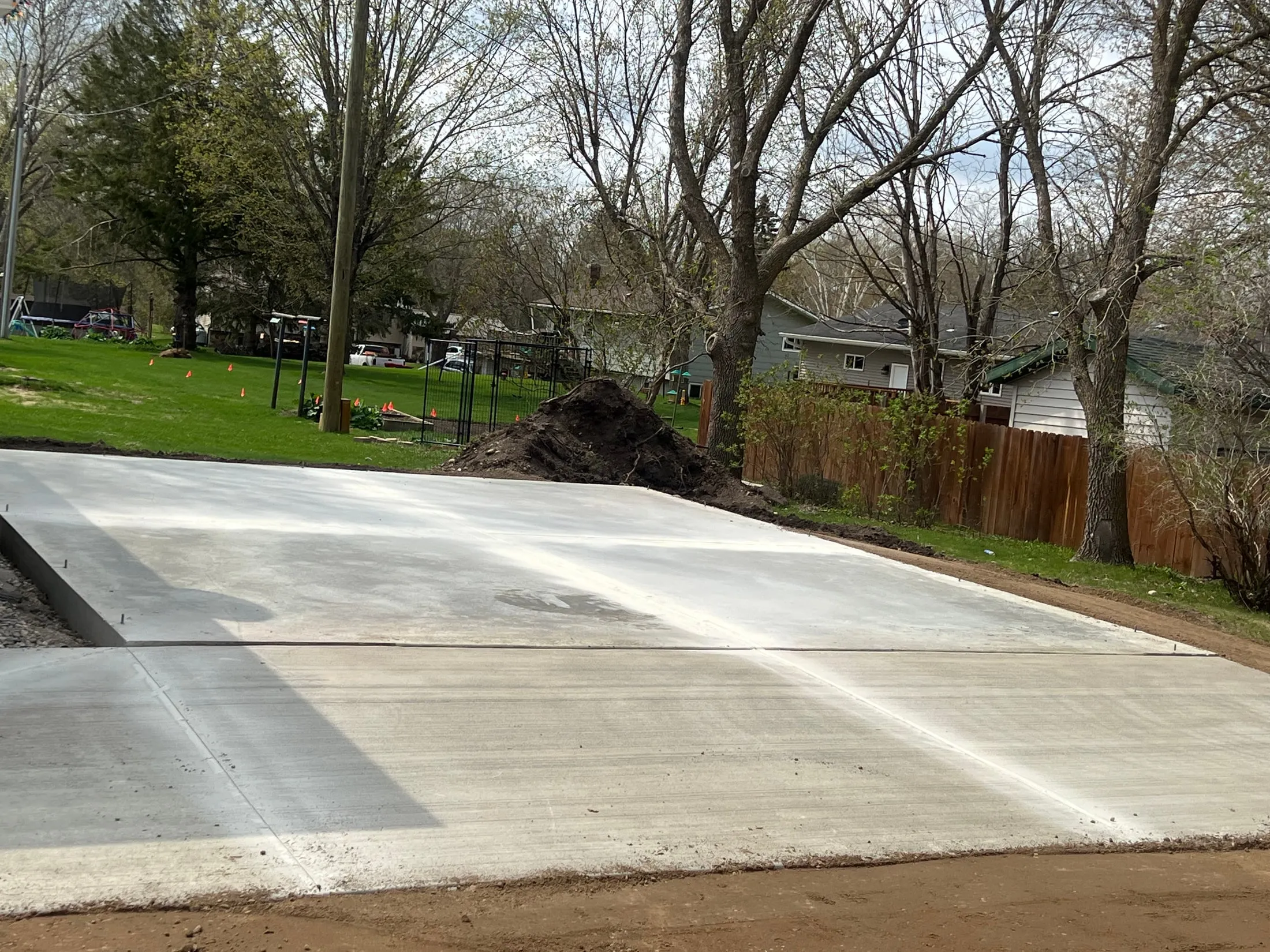 After the pour: concrete slab with visible joints at the same blue-garage project.
