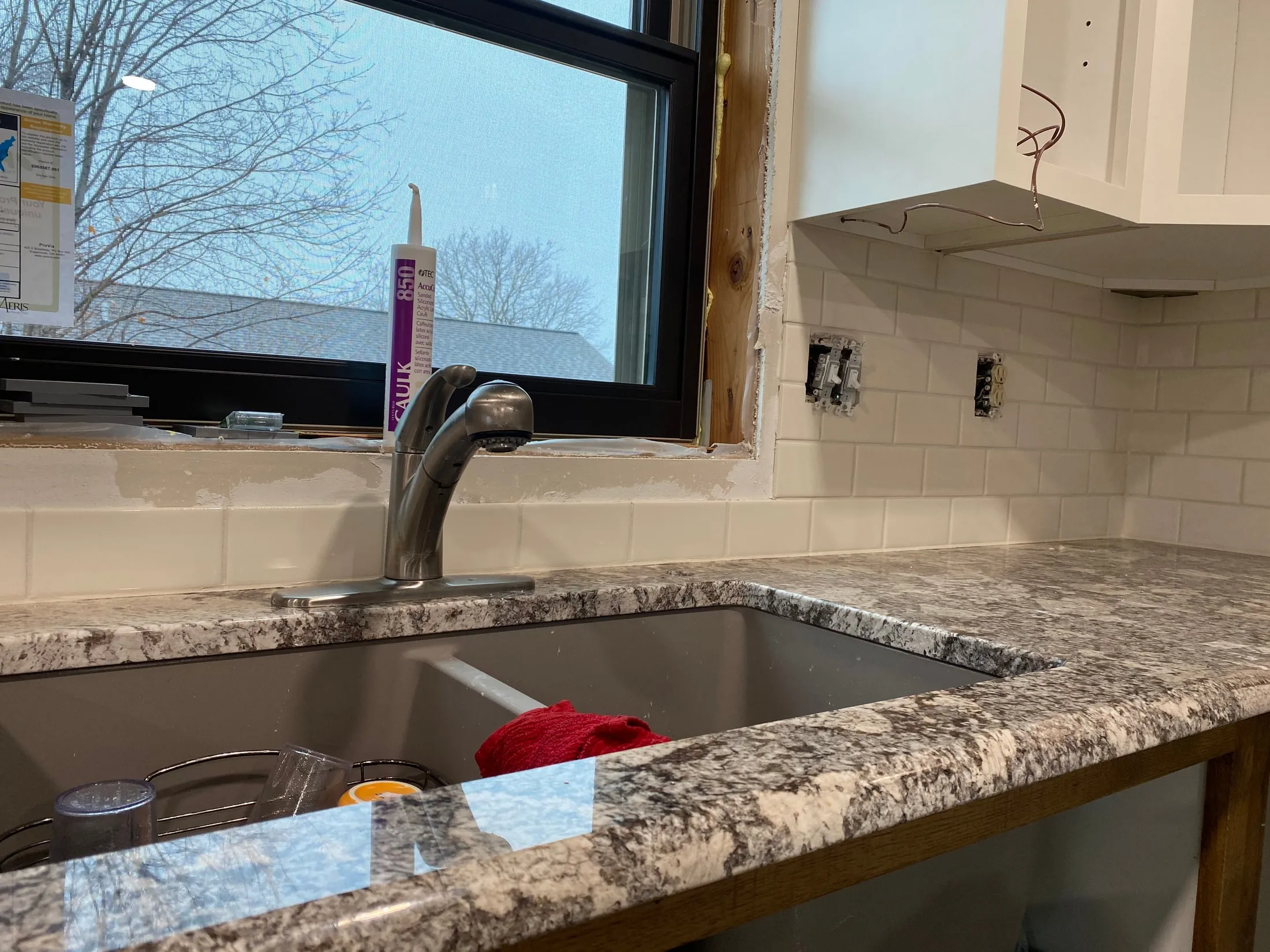 Backsplash coursework detail at the kitchen window.