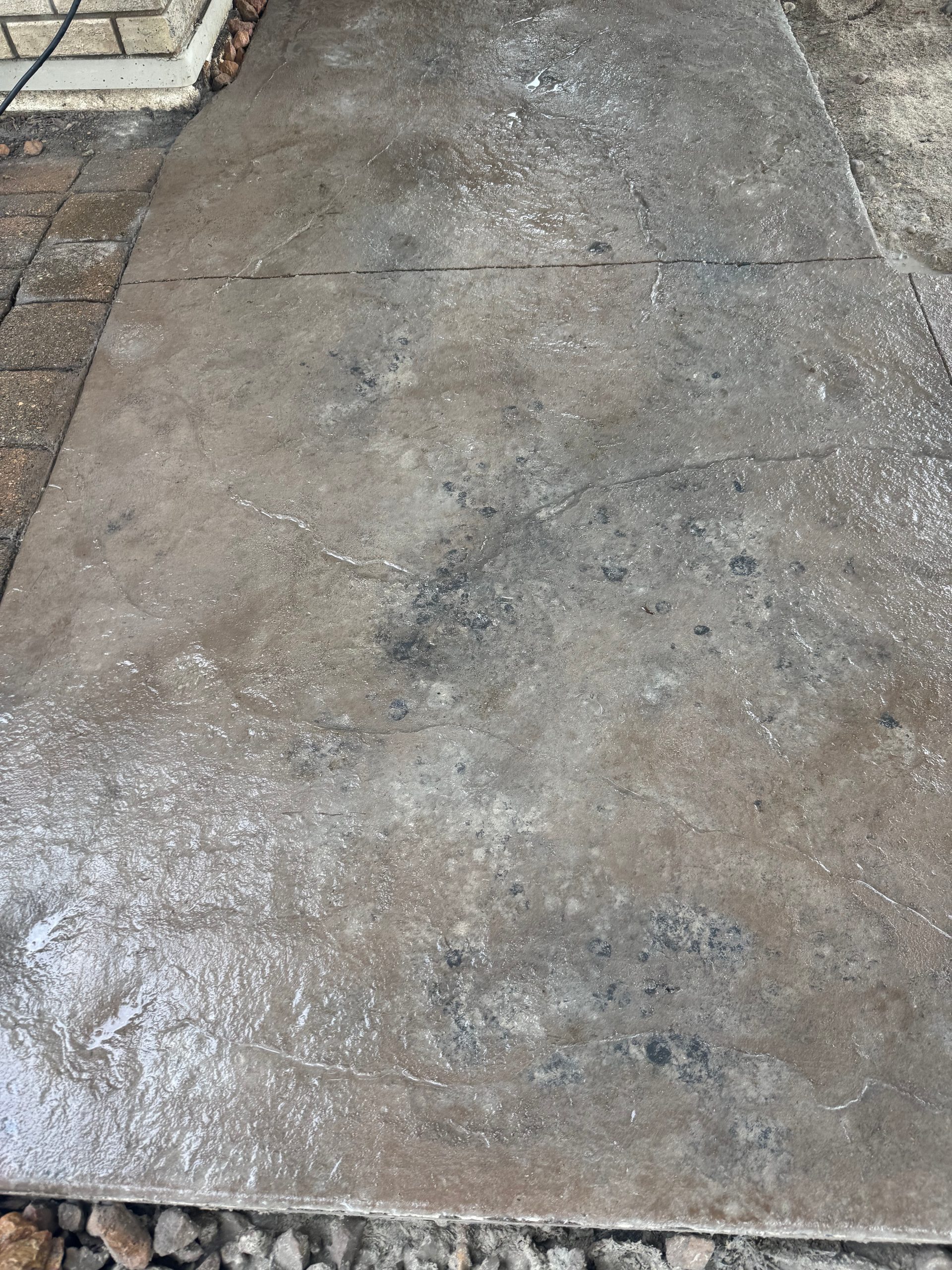 Stamped concrete patio with slate stone pattern and control joint detail in west-central Minnesota.